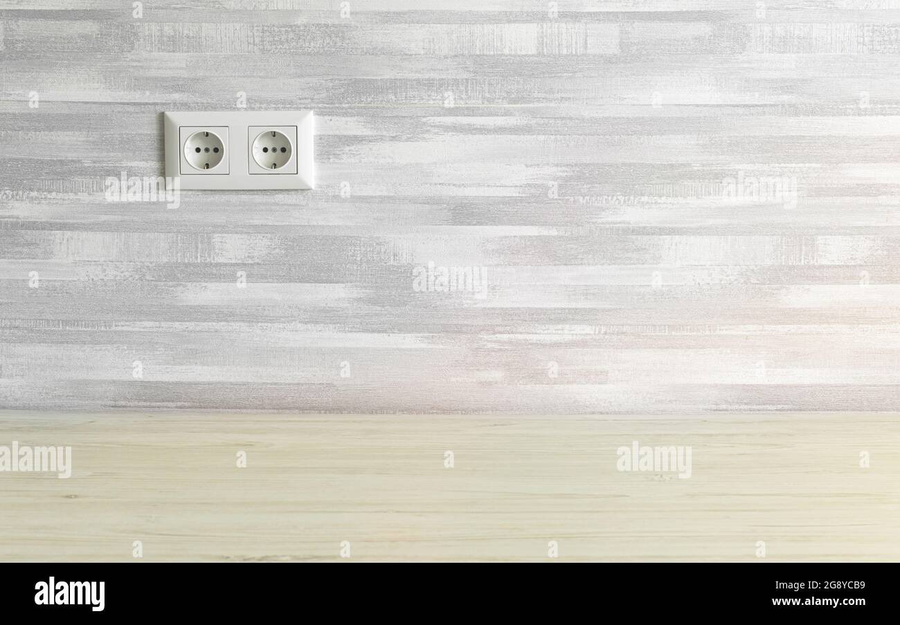 Simple home interior with power socket on gray wall, copy space Stock Photo