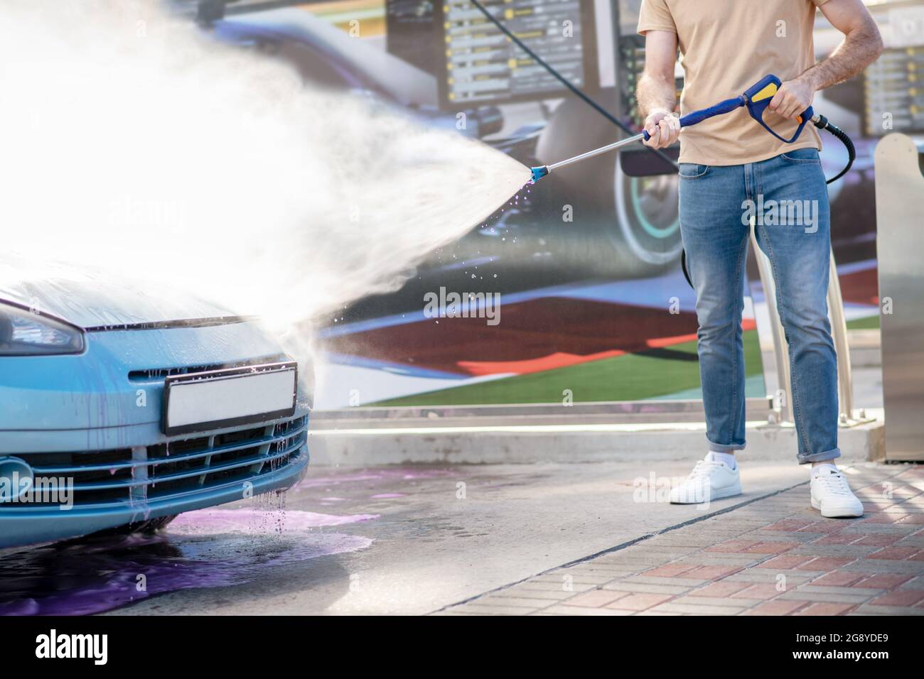Male hands watering car with water from hose Stock Photo Alamy