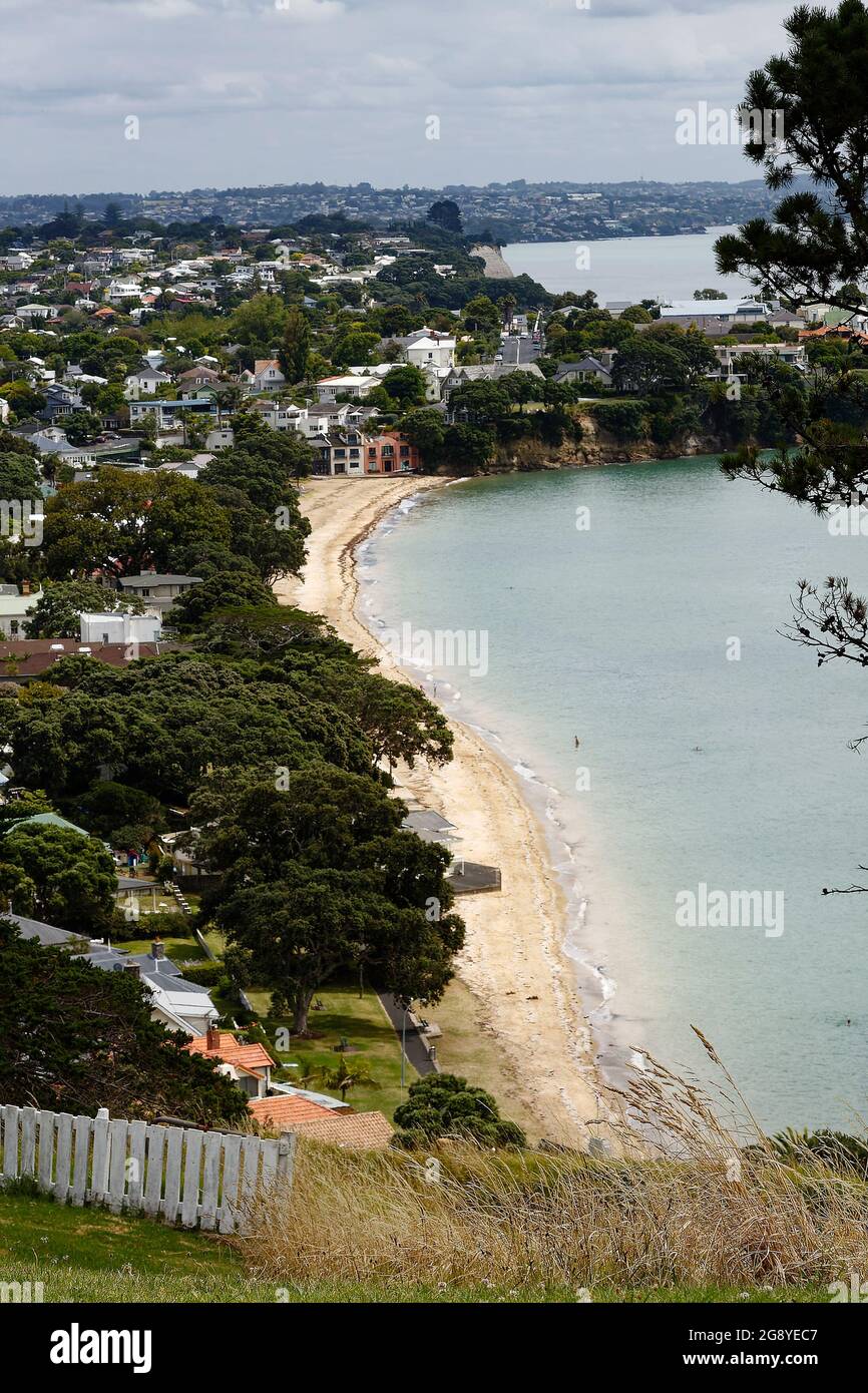 coastline, sand beach, water, houses, trees, water, cove, cloudy sky, Devonport; views from North Head,  Auckland, New Zealand Stock Photo