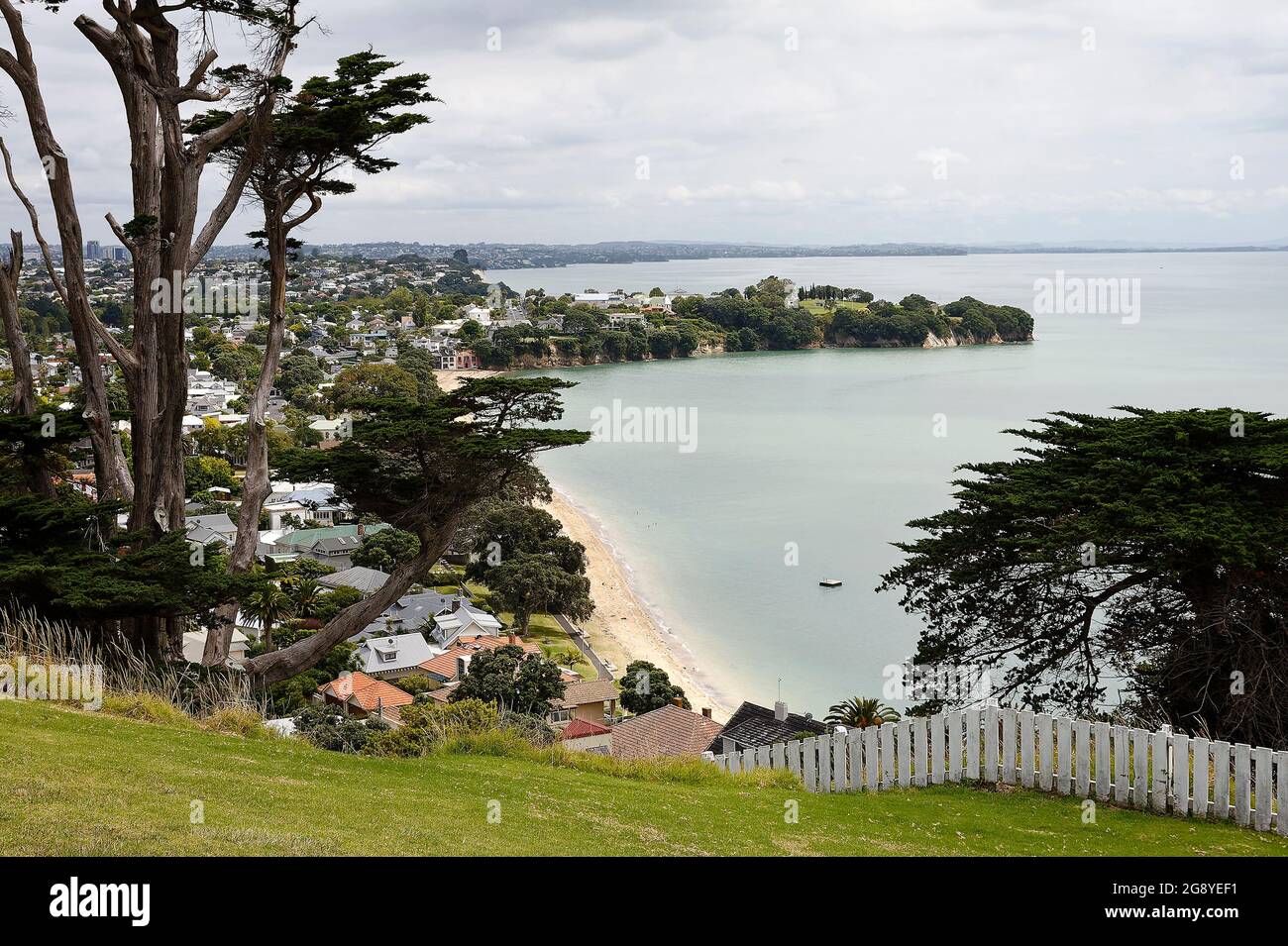 coastline, sand beach, water, houses, trees, water, cove, peninsula, cloudy sky, Devonport; views from North Head, dead space, Auckland; New Zealand Stock Photo