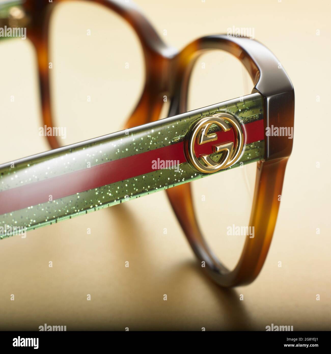 Gucci Spectacles frames close up and side slightly from the rear showing logo on side of frames. Selective focus Stock Photo -