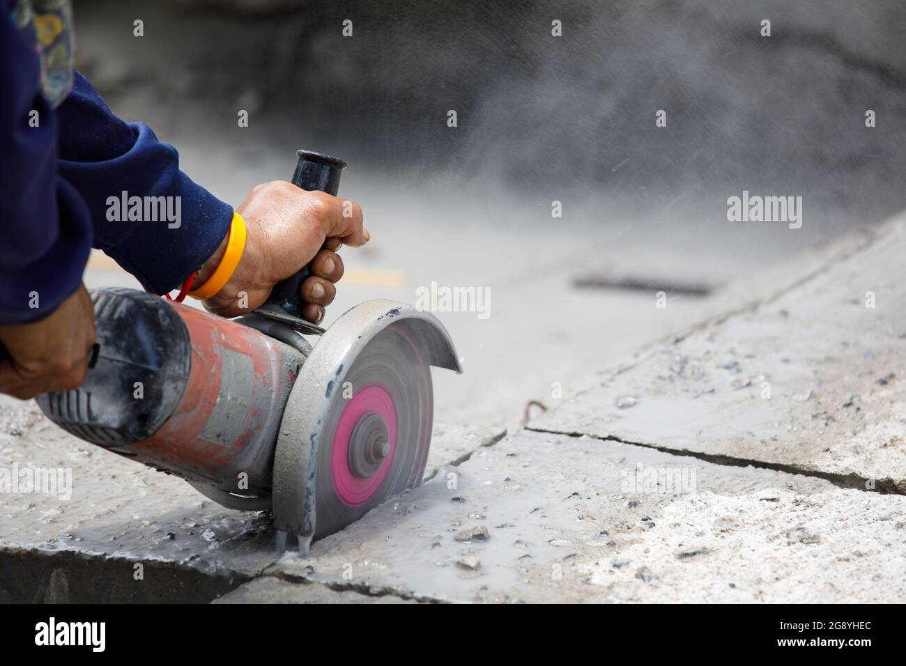 Worker using tool to cut concrete floor Stock Photo Alamy