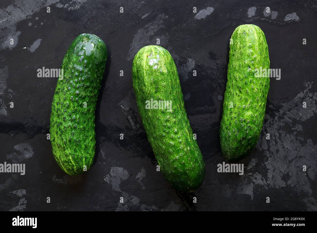 Fresh cucumber on a dark background. Vegetarian and raw food diet. Stock Photo
