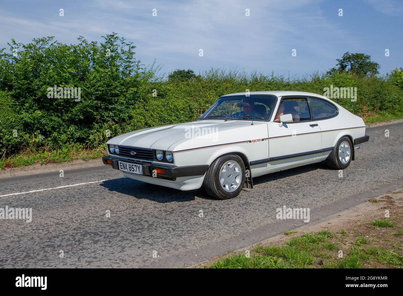 1983 80s, eighties white Ford Capri 2792cc petrol 2dr coupe, en-route to Capesthorne Hall classic July car show, Cheshire, UK Stock Photo