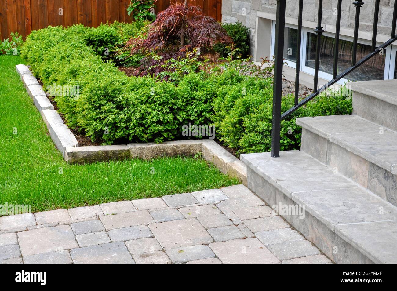 Square cut wet lay flagstone, a tumbled paver landing and ledge rock