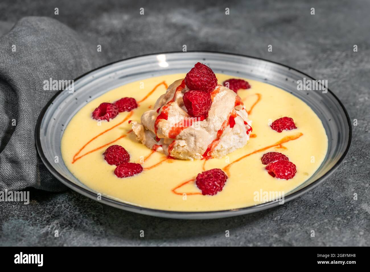 Floating island dessert made of meringue floating on vanilla custard