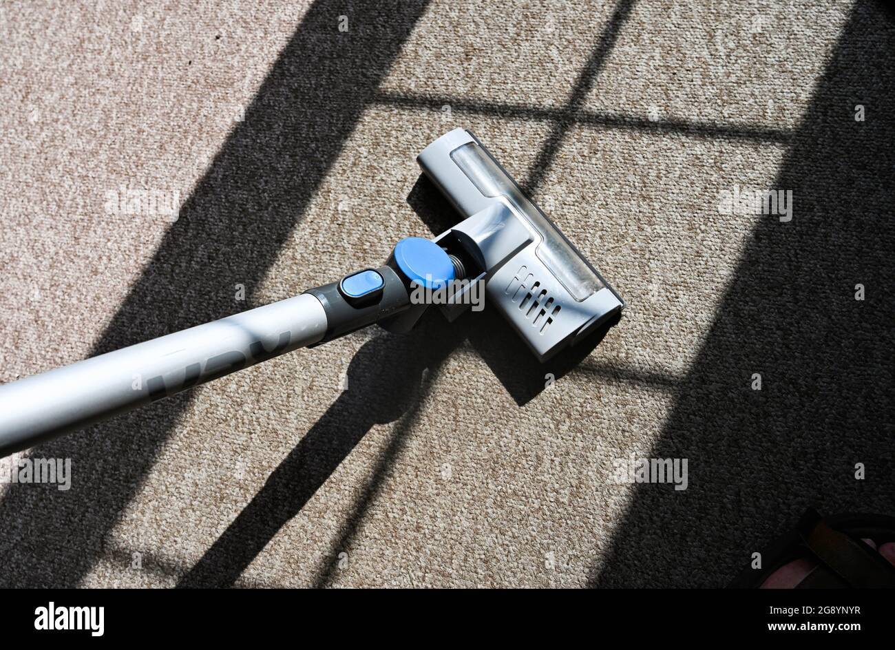 Lightweight rechargeable Cordless Vac vacuum cleaner being used on