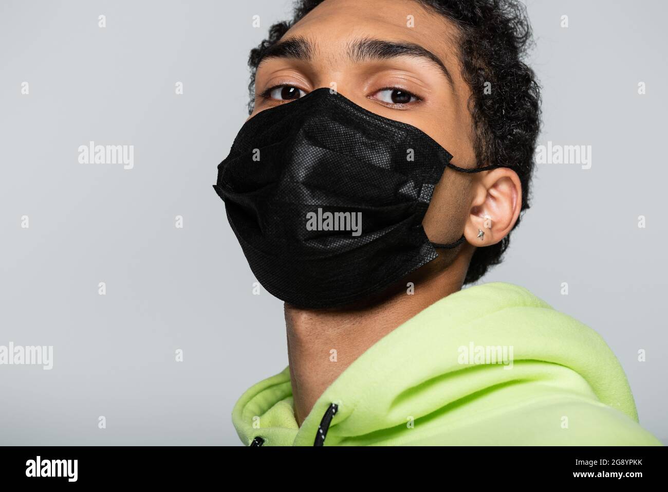 african american guy in black medical mask looking at camera isolated ...