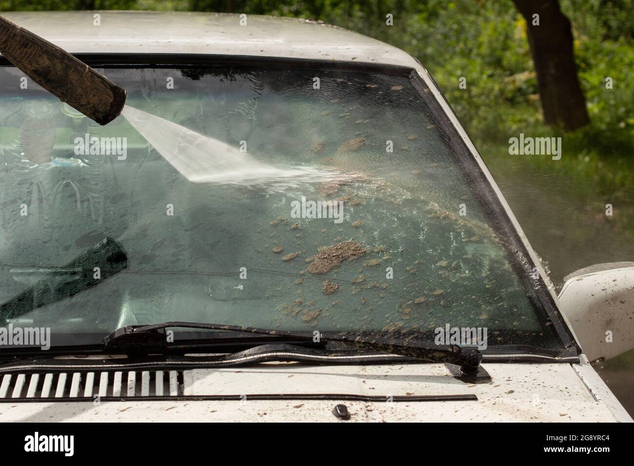 Washing the windshield from dirt. The car is washed by the pressure of