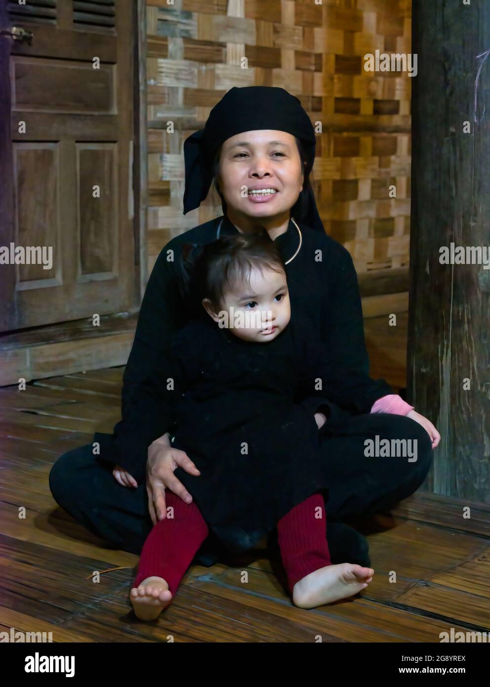 Older woman grandmother with toddler at Thai Hai ethnic village, Thai Nguyen province, Northern Vietnam, Asia Stock Photo