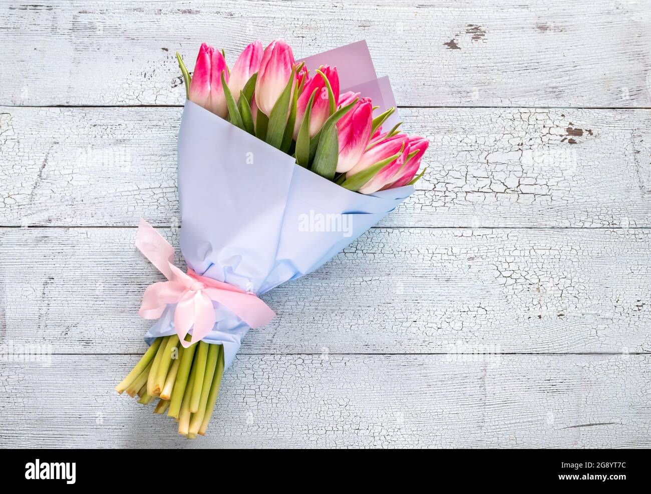 Bouquet of pink tulips on the wooden background Stock Photo - Alamy