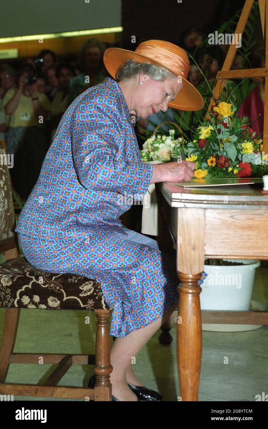 Her Majesty Queen Elizabeth signing visitors book in 1994 Stock Photo