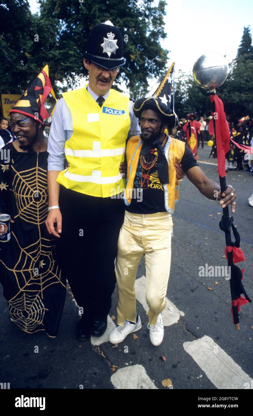 Handsworth Carnival in Birmingham Uk 1988 PC Colin Pearson with revellers Stock Photo