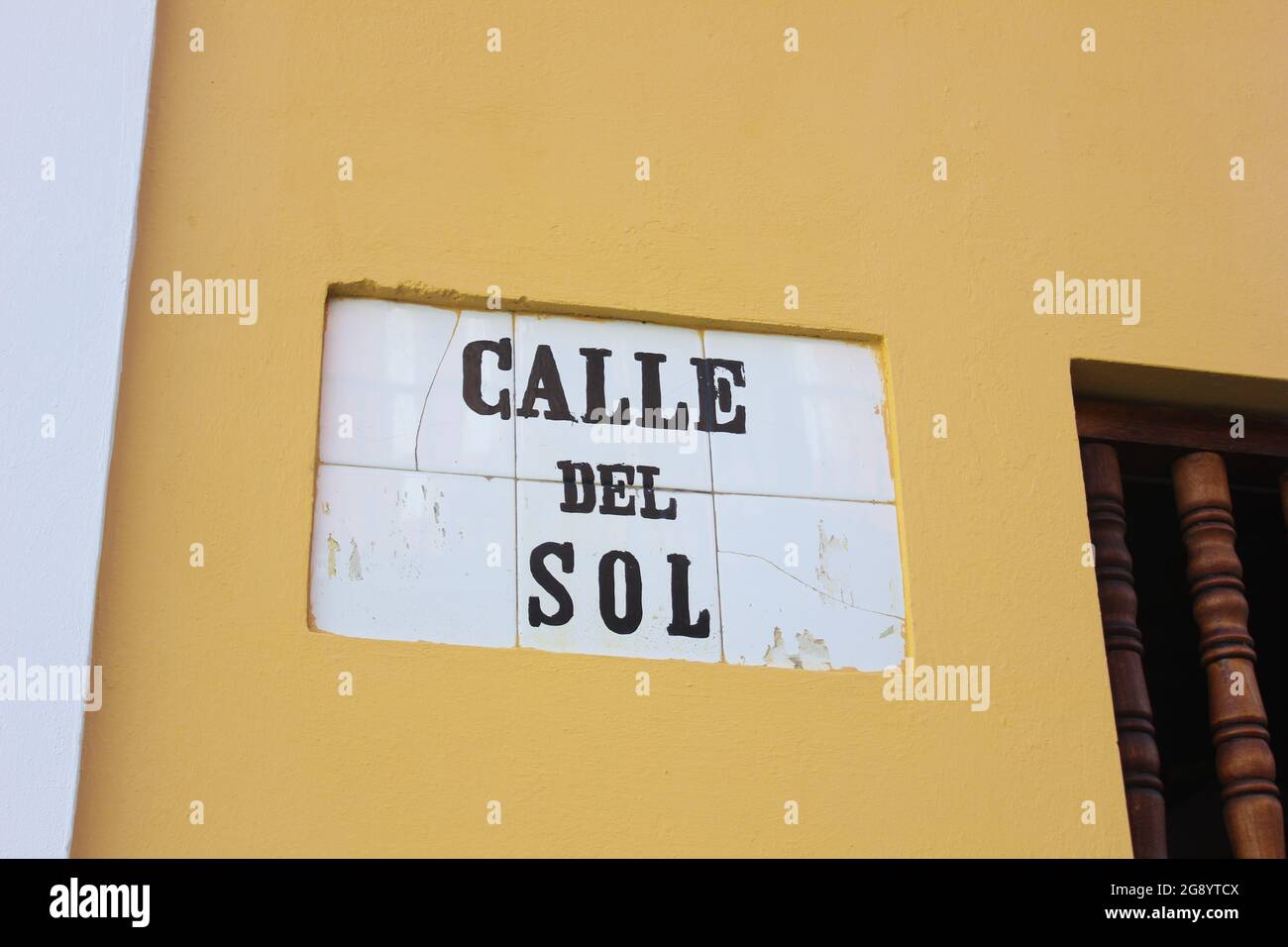 The heavily weather beaten tile street marker identifying Calle de San Sol in Old San Juan, Puerto Rico Stock Photo