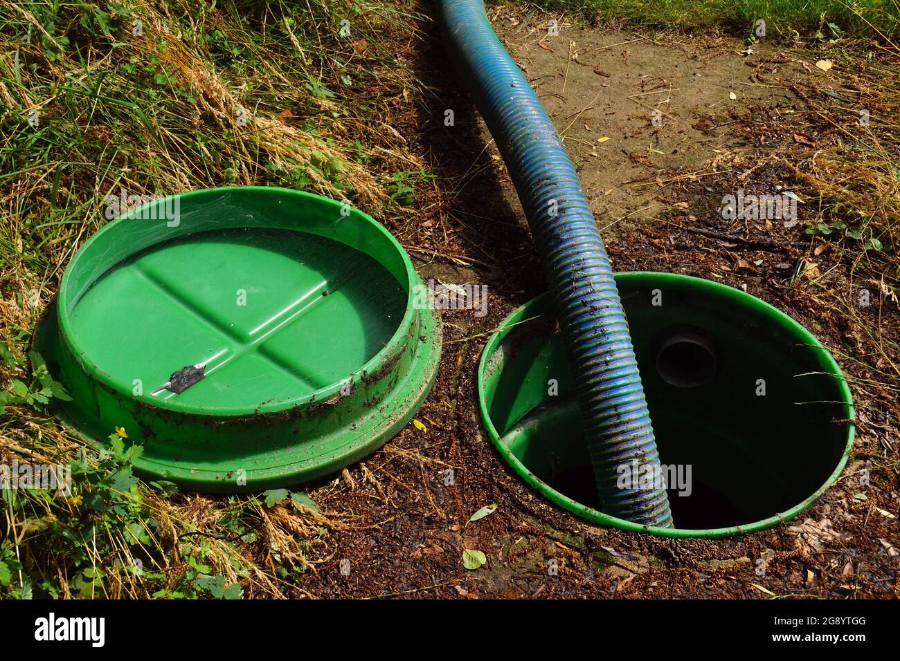Pipe in the drainage pit. Pumping out sewage from a septic tank. Stock Photo