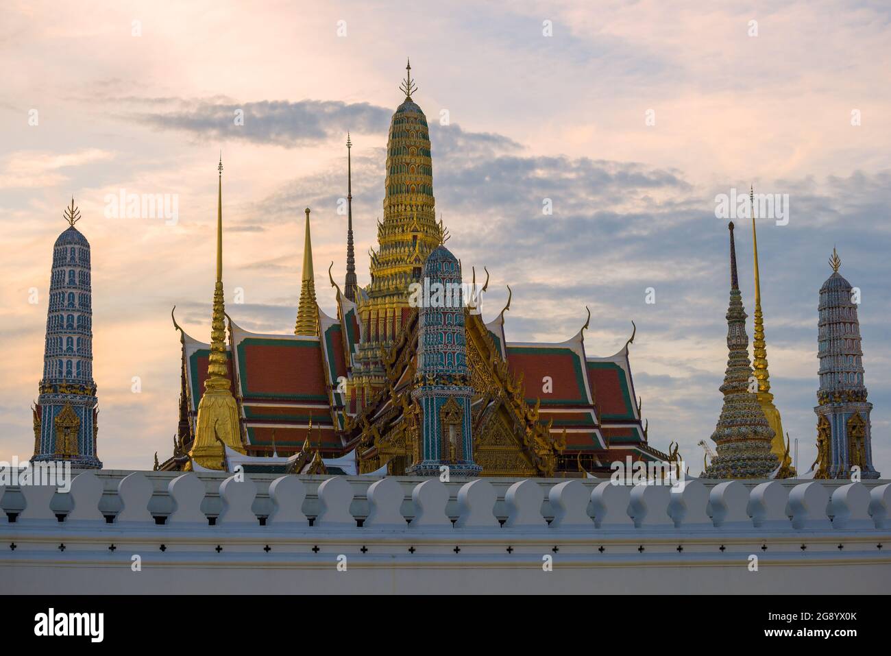 Prangs of the Grand Royal Palace against the background of the evening sky. Bangkok, Thailand Stock Photo