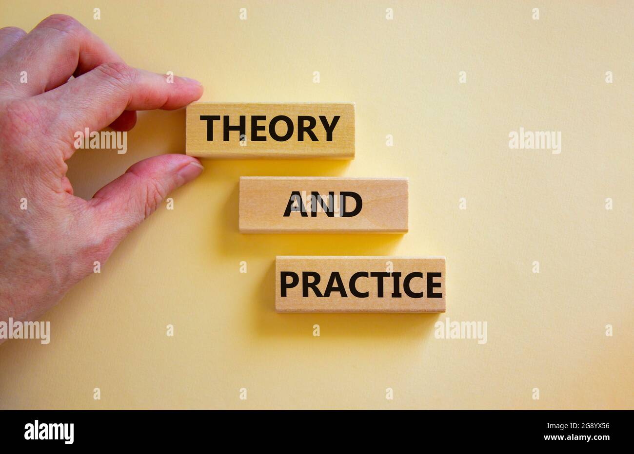 Theory and practice symbol. Wooden blocks with words 'Theory and ...