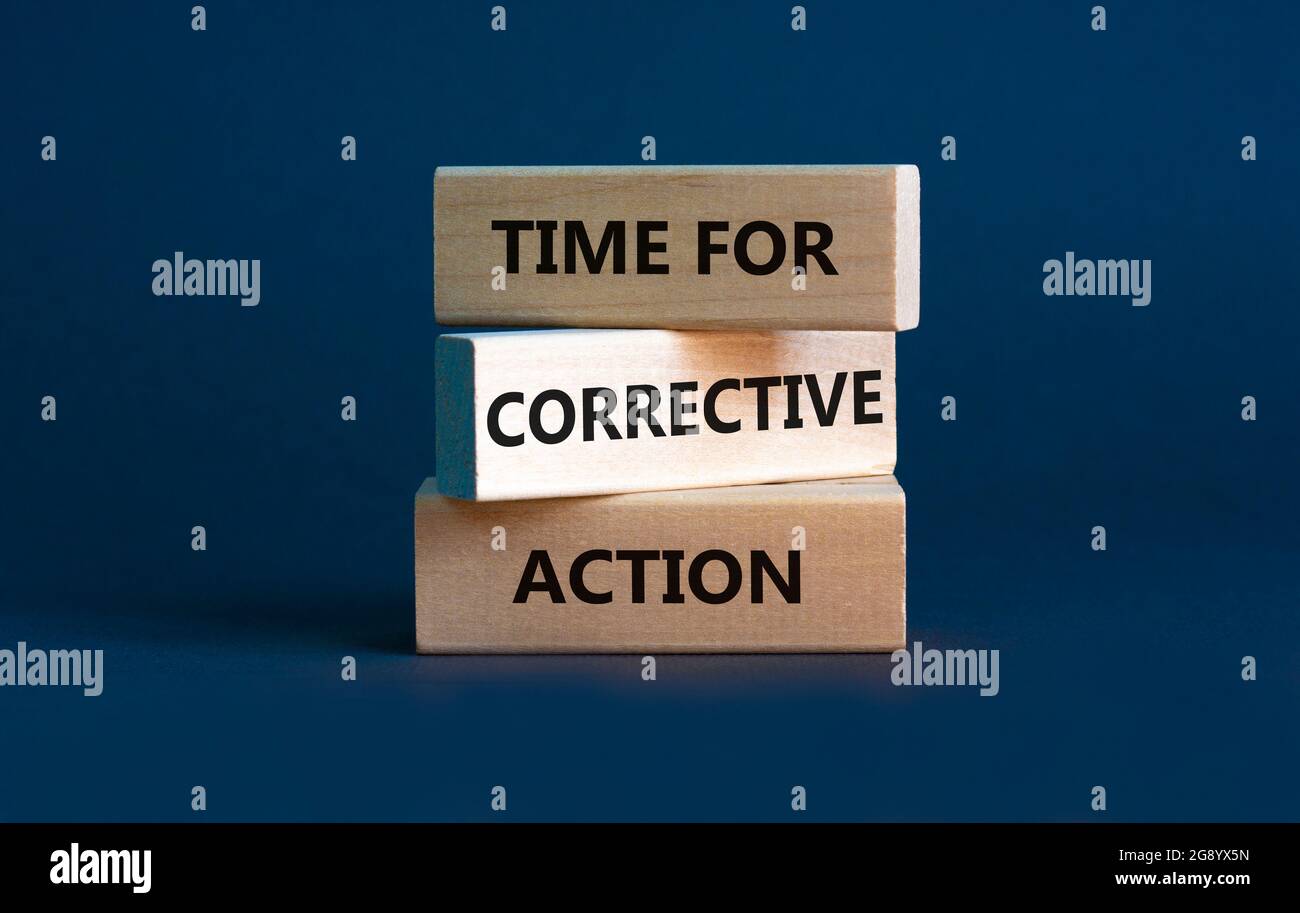 Time for corrective action symbol. Wooden blocks with words 'Time for corrective action' on a beautiful grey background. Business, time for corrective Stock Photo