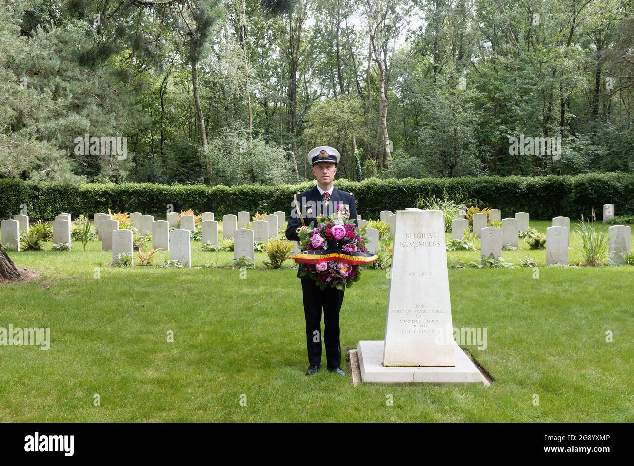 Captain Flamant Defence Attache of the London Embassy of the Kingdom of Belgium at the Belgian Memorial at Brookwood Military Cemetery where he is about to place a wreath on behalf of the Belgian Ambassador. Belgian headstones in the background. Stock Photo