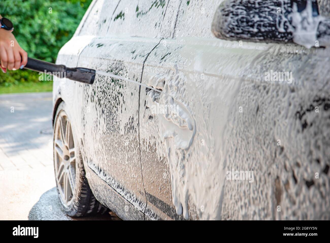 Car wash. The process of washing a car with active foam under pressure