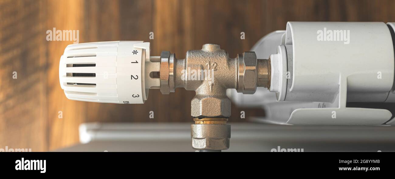 Radiator heating controller banner closeup in modern wooden interior ...