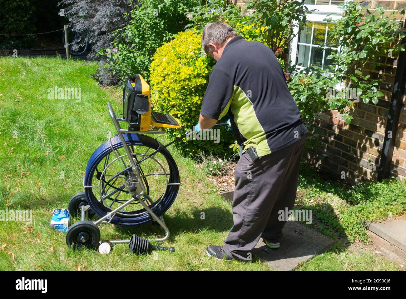 Contractors with a camera and roll of fibre optic cable investigate a blocked sewer drain pipe system for blockage & the cause of the problem. UK. (127) Stock Photo
