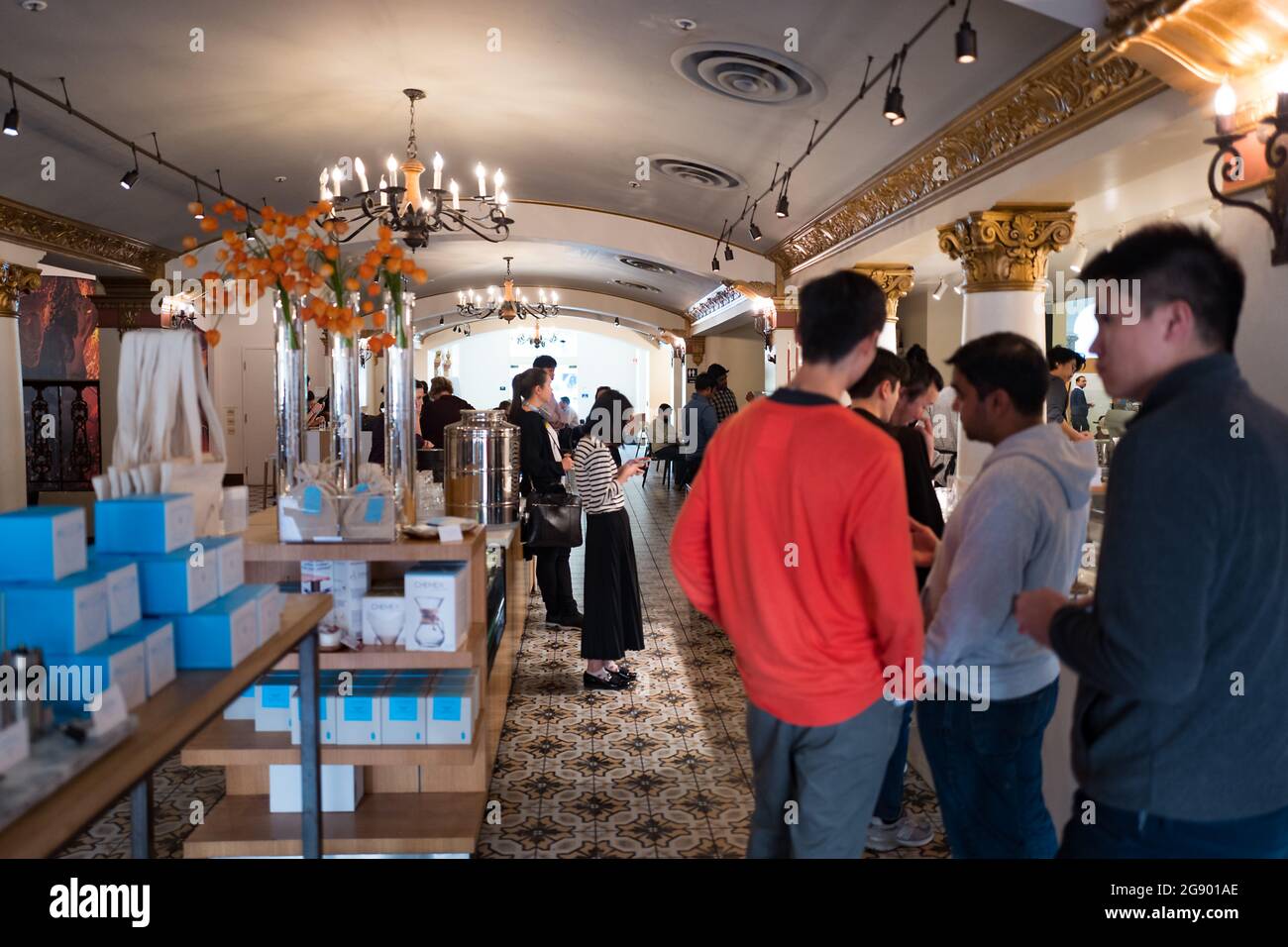 People stand in line to purchase drinks at the Blue Bottle Coffee shop