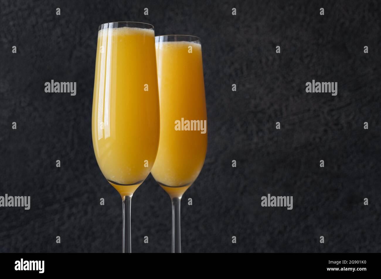 Two glasses of Buck's Fizz cocktail on black background Stock Photo