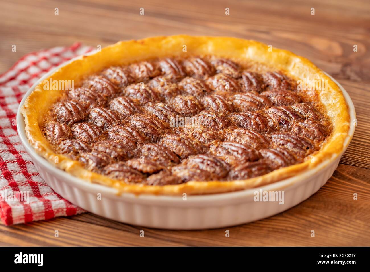 Pecan pie - traditional southern US dessert on wooden table Stock Photo