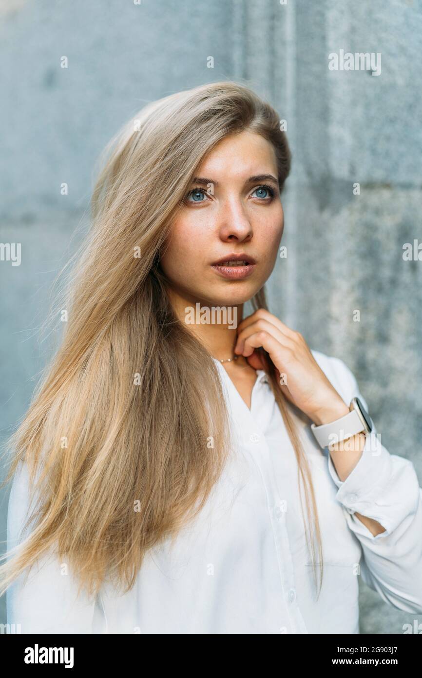 Young beautiful woman with blond hair looking away Stock Photo - Alamy