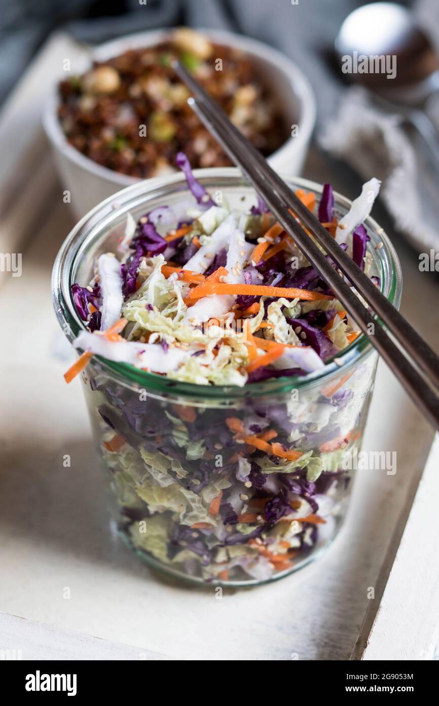 Thai food in glass jar with steel chopsticks on tray Stock Photo