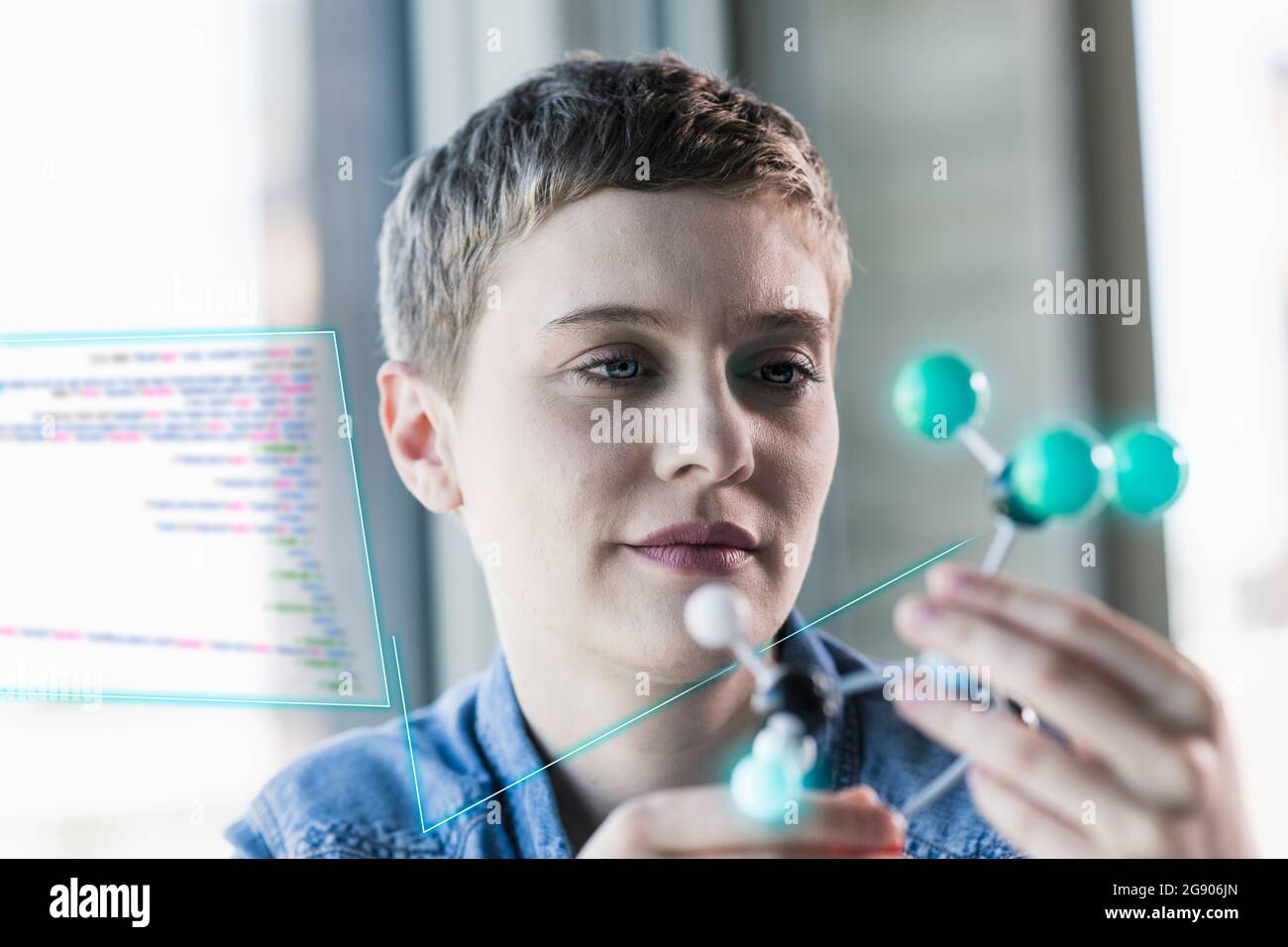 Businesswoman looking at molecular structure at office Stock Photo