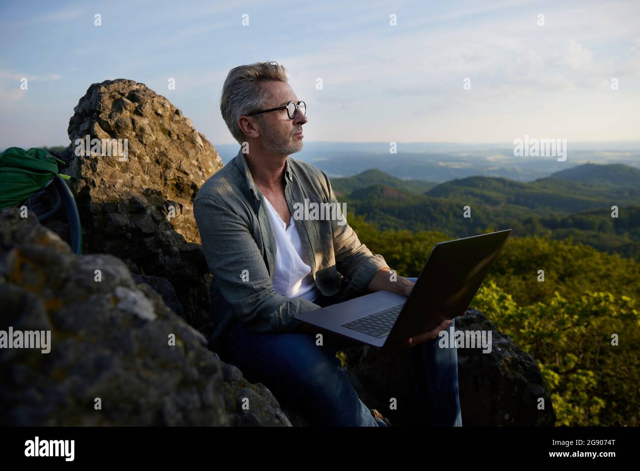 Man sitting on top mountain hi-res stock photography and images - Alamy