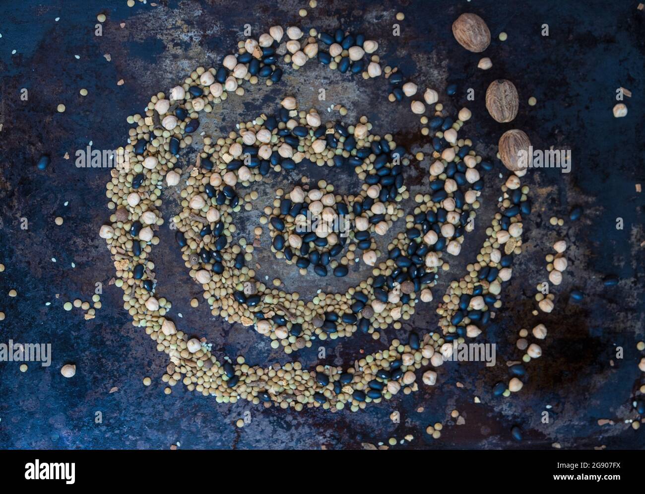 Spiral shape made of various spices and legumes Stock Photo