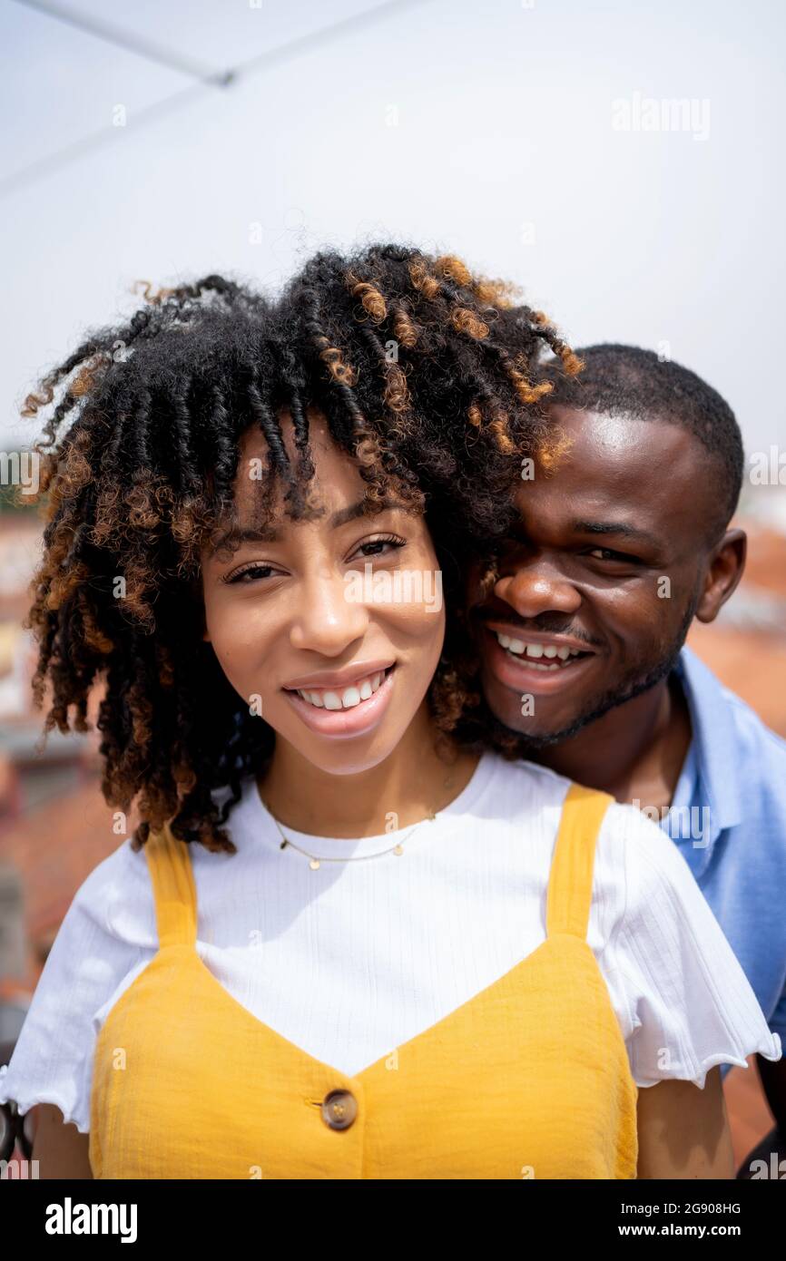 Multi-ethnic young couple smiling during sunny day Stock Photo