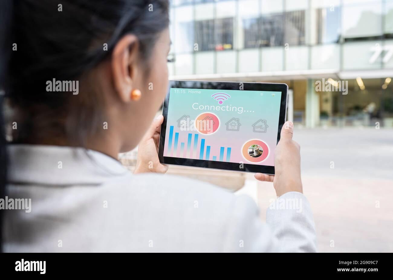 Businesswoman using digital tablet with house icon Stock Photo