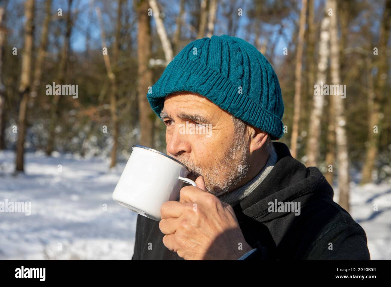 Senior man drinking coffee on sunny day Stock Photo