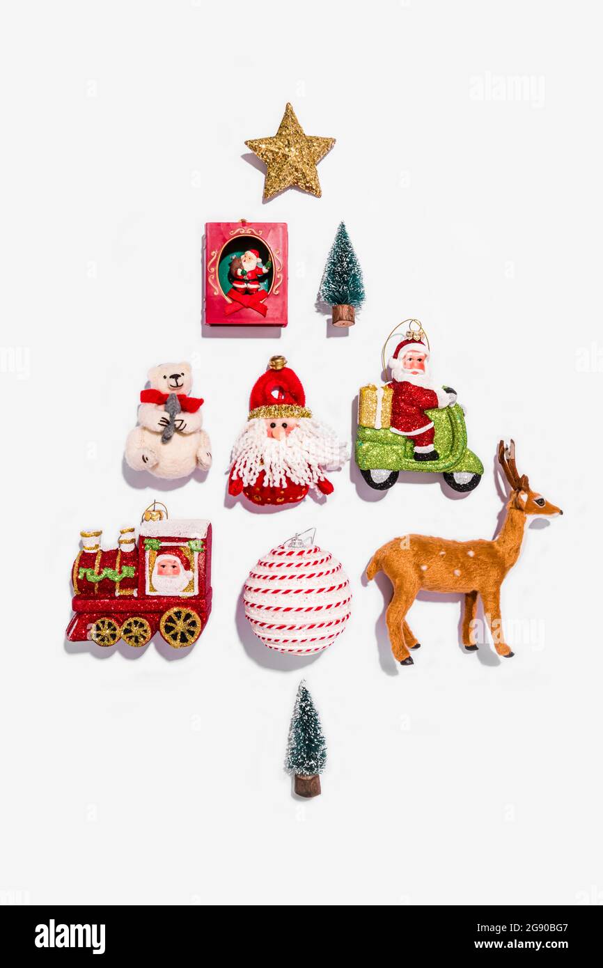 Studio shot of various Christmas decorations arranged into tree shape Stock Photo