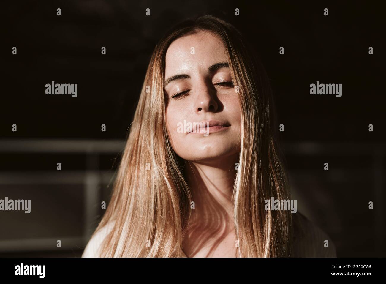 Beautiful young blond woman with eyes closed Stock Photo - Alamy