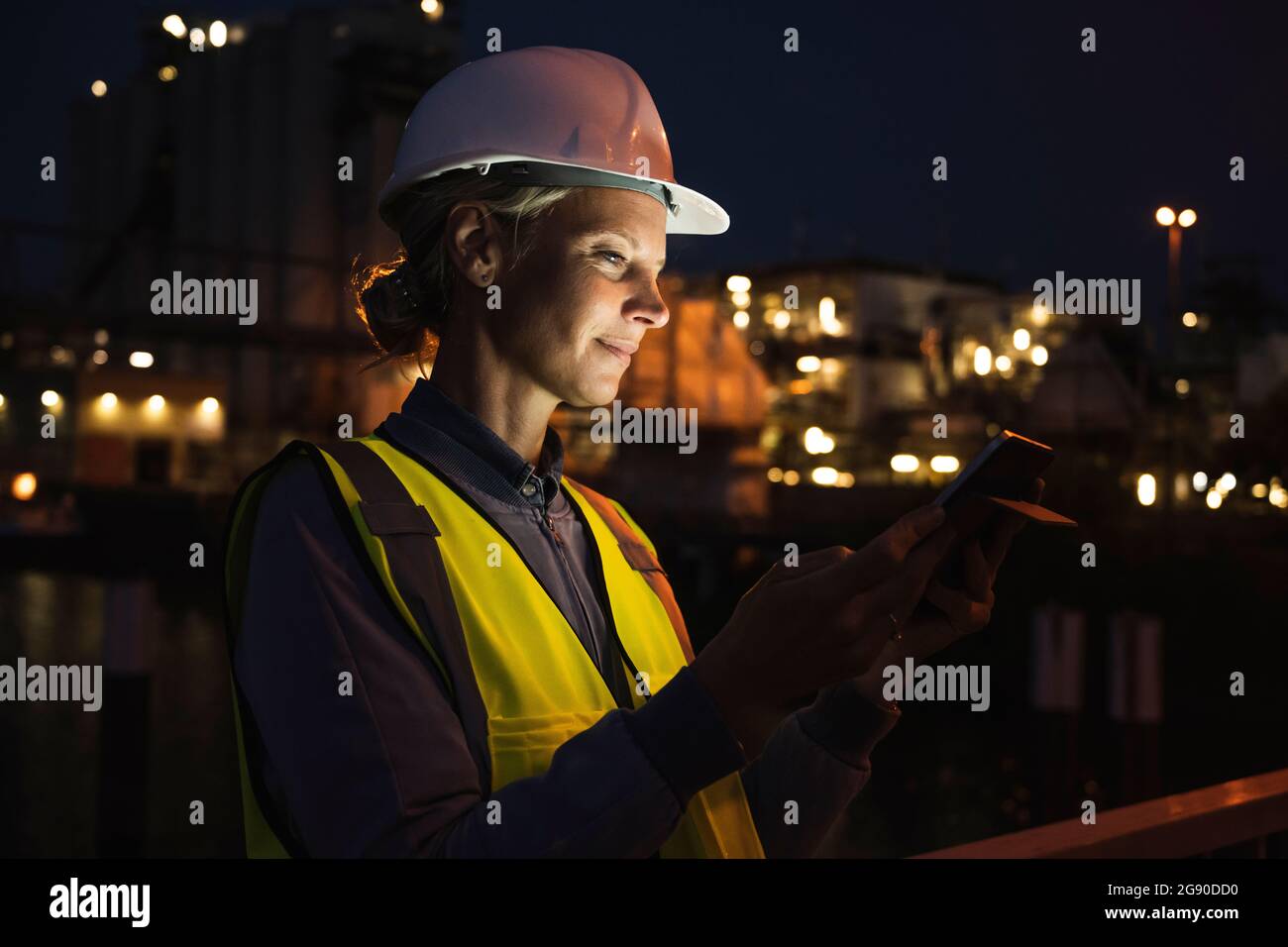 Mature female professional using digital tablet at night Stock Photo