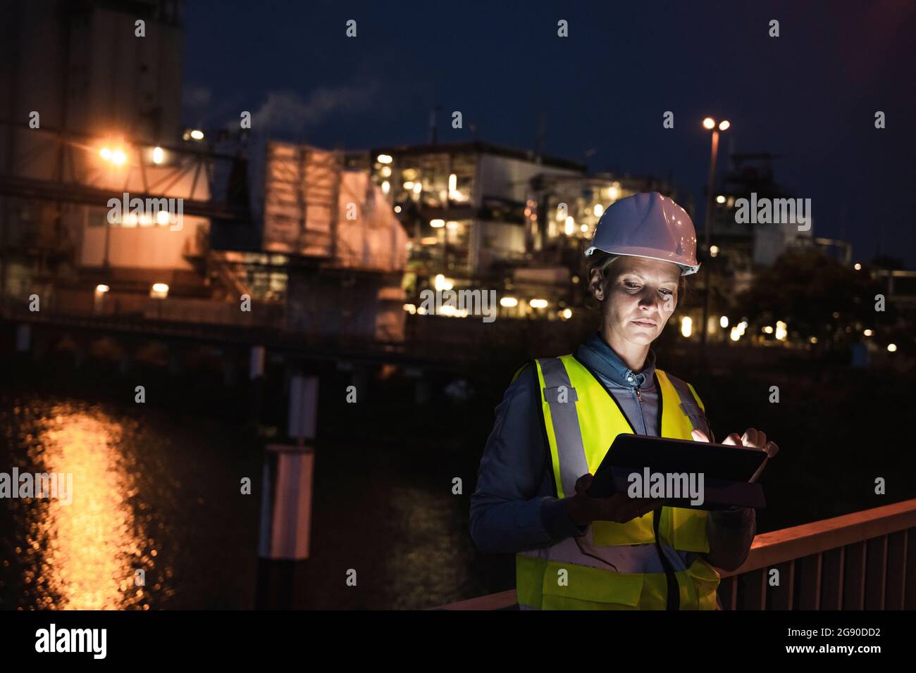 Mature female professional using digital tablet at night Stock Photo