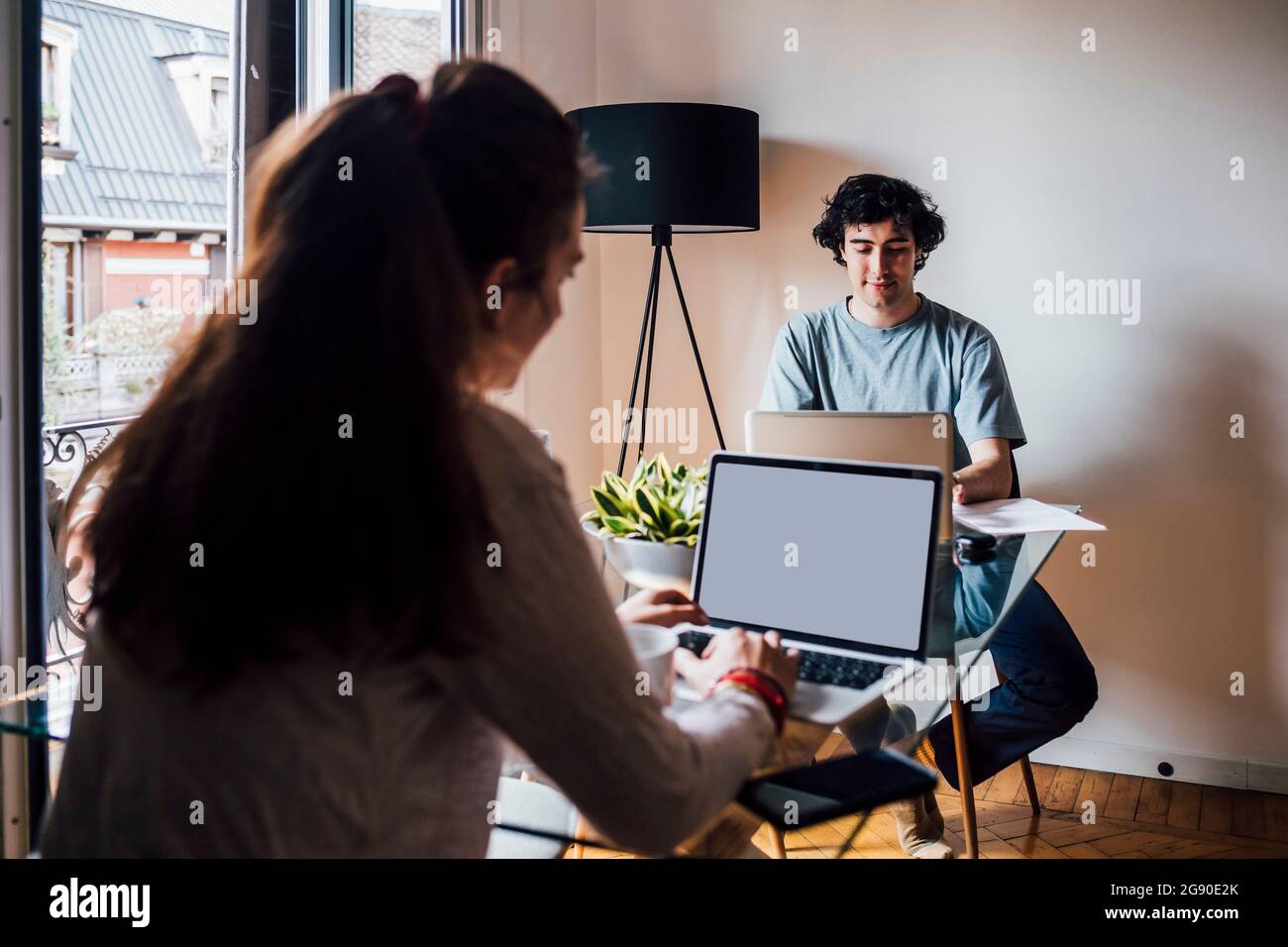 Couple using laptops while working at home Stock Photo