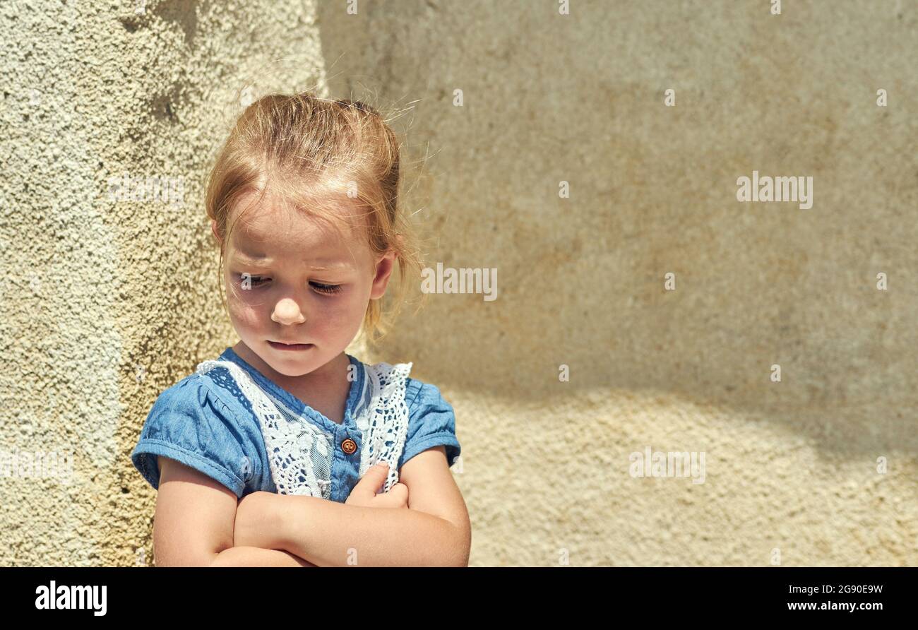 Sad little girl Upset girl Mistake regret.ashamed sad little child looking down Stock Photo