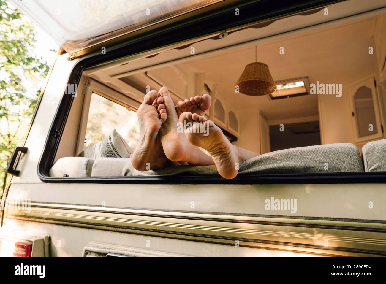 Young couple's feet on motor home window Stock Photo