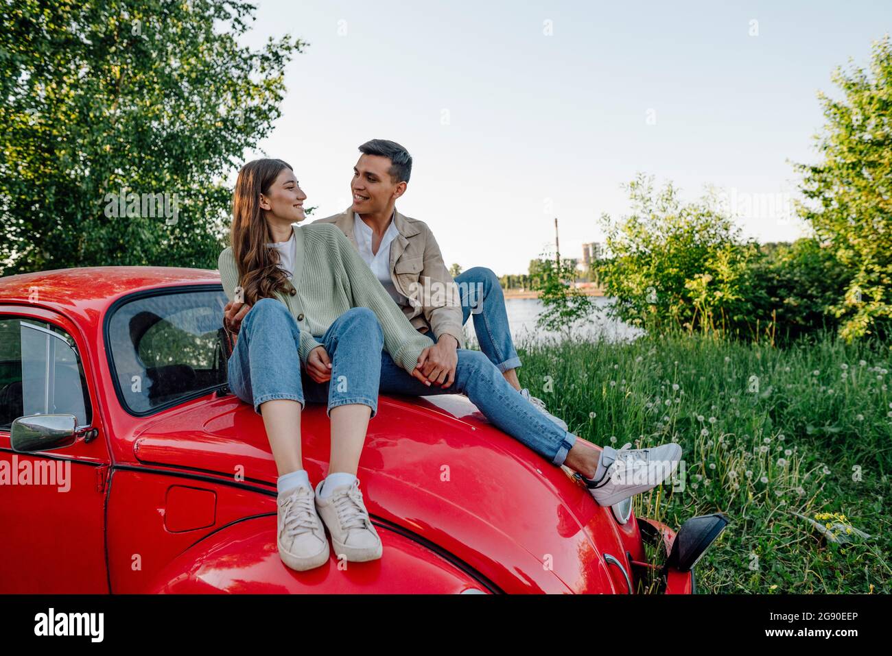 Premium Photo | Well-dressed attractive couple leaning on a luxury car  outdoors against the skyscraper.