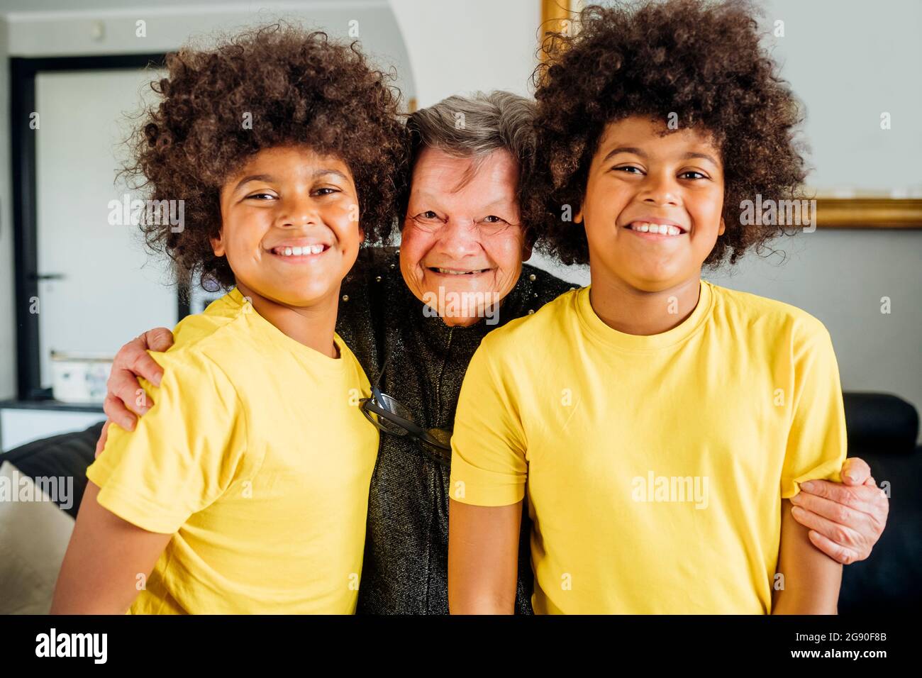 grandmother-embracing-twin-grandsons-at-home-stock-photo-alamy