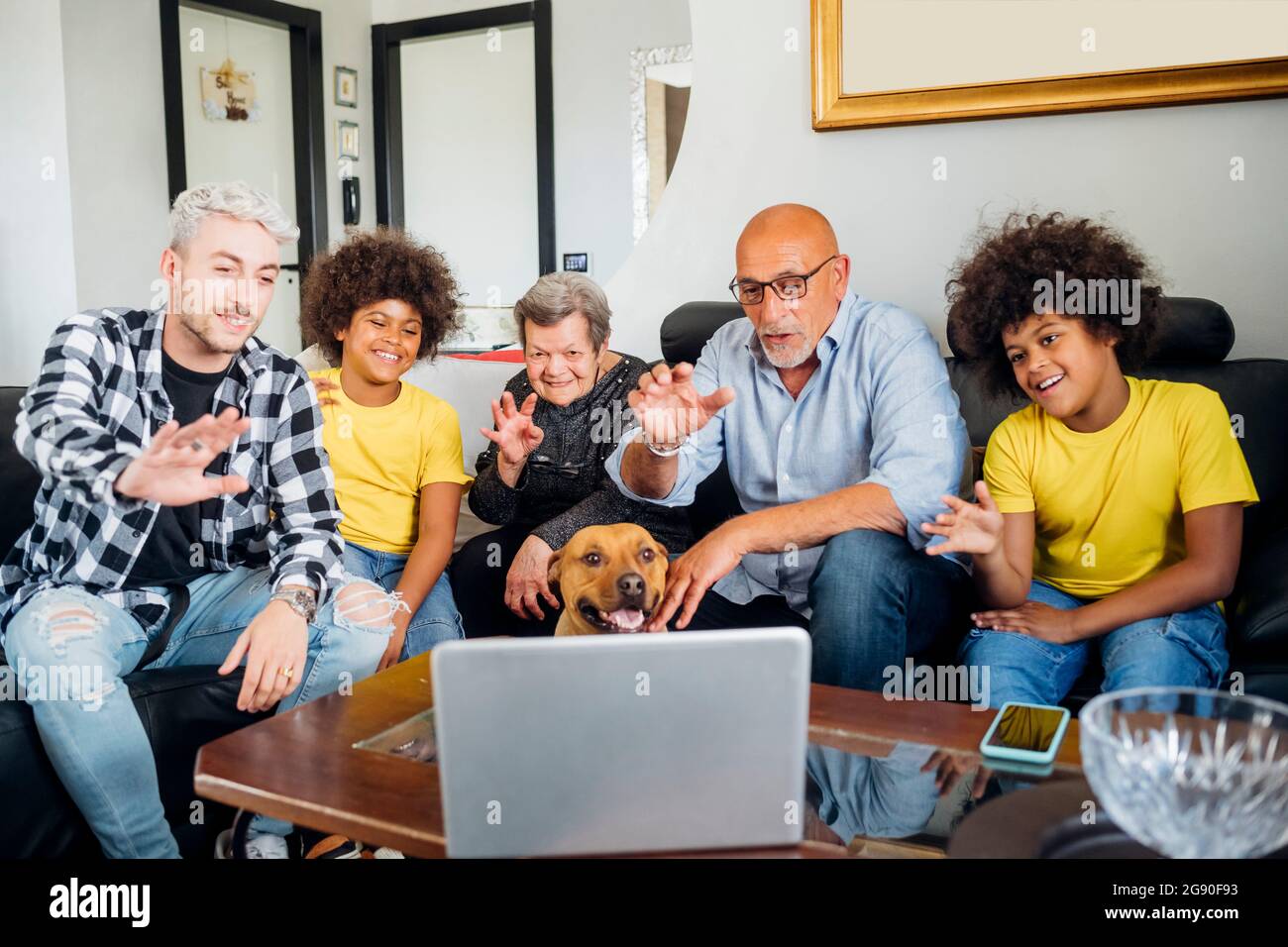 Multi-ethnic family greeting during video call on laptop at home Stock Photo