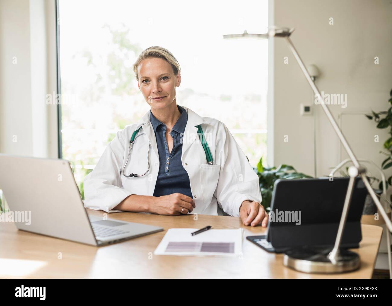 Professional doctor sitting table hi-res stock photography and images ...