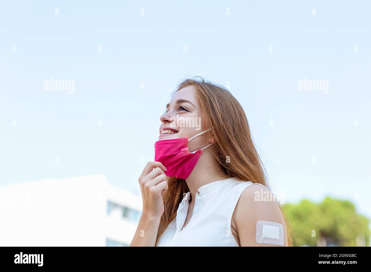 Woman removing medical face hi-res stock photography and images - Alamy