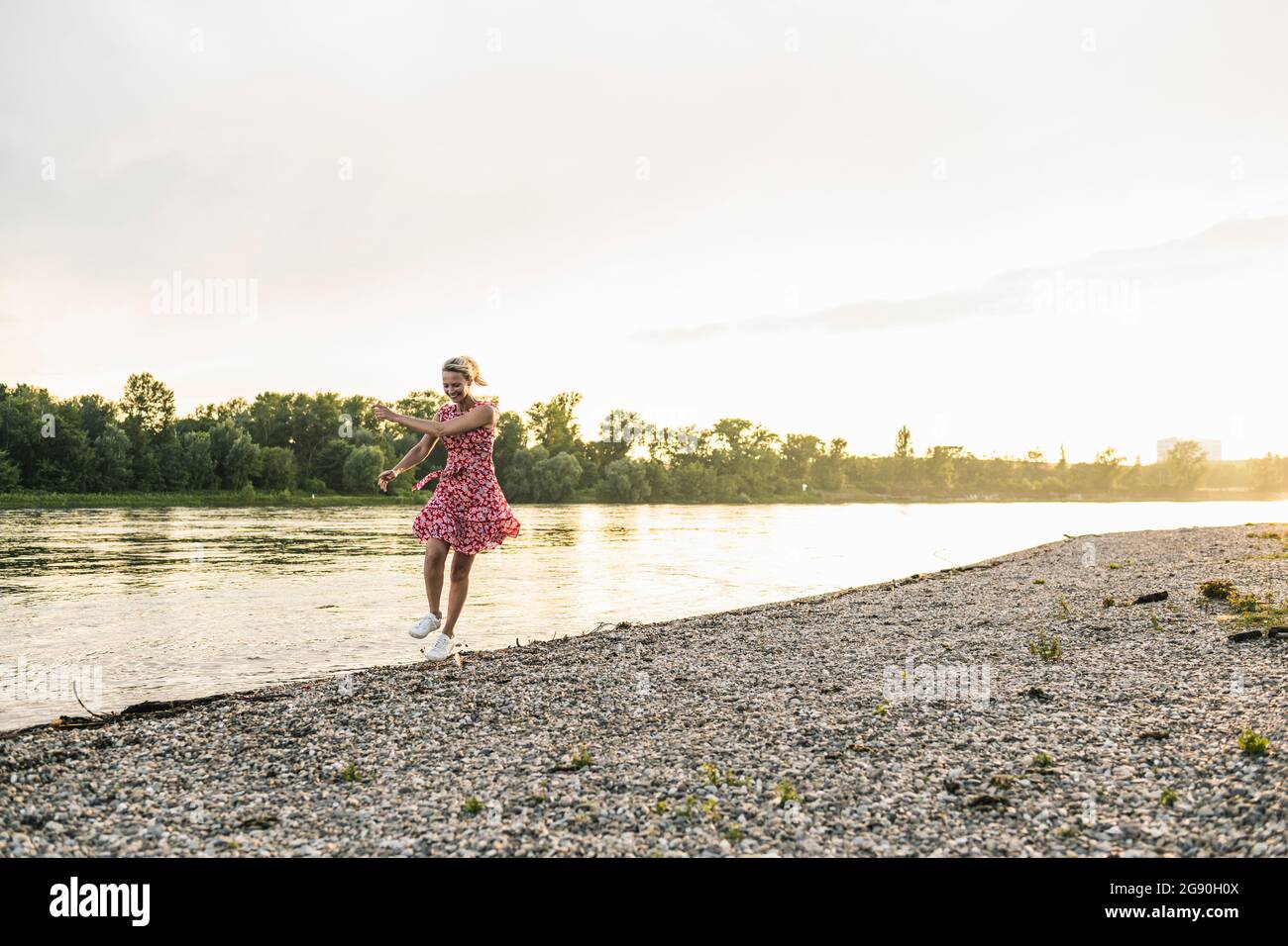 Playful woman dancing at riverbank Stock Photo - Alamy